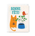 Greeting card with an orange cat, plant, and bird illustration, featuring 'Bonne Fète!' text.