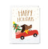 Greeting card with a dog driving a red car carrying a Christmas tree and presents, with 'Happy Holidays' text.
