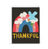 Greeting card with a blue bird holding a leaf, rainbow, and 'THANKFUL' text on a black background.