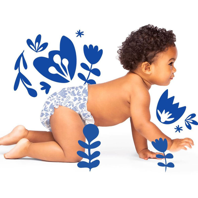Baby crawling on a white background with blue floral designs