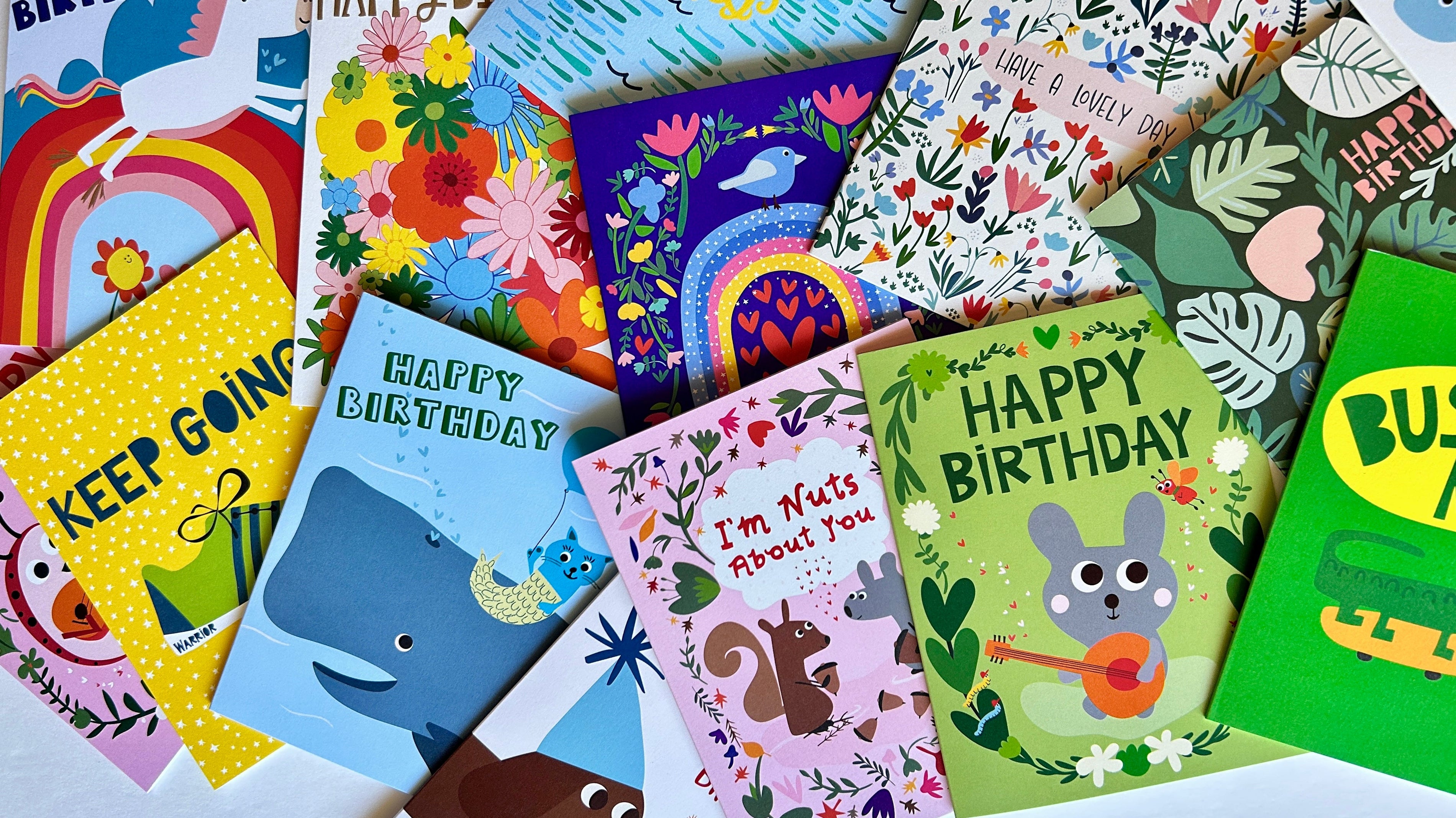 Collection of colorful greeting cards with various designs and text.