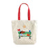Tote bag with cartoon design of a dog and birds on a bench, red handles, on a white background