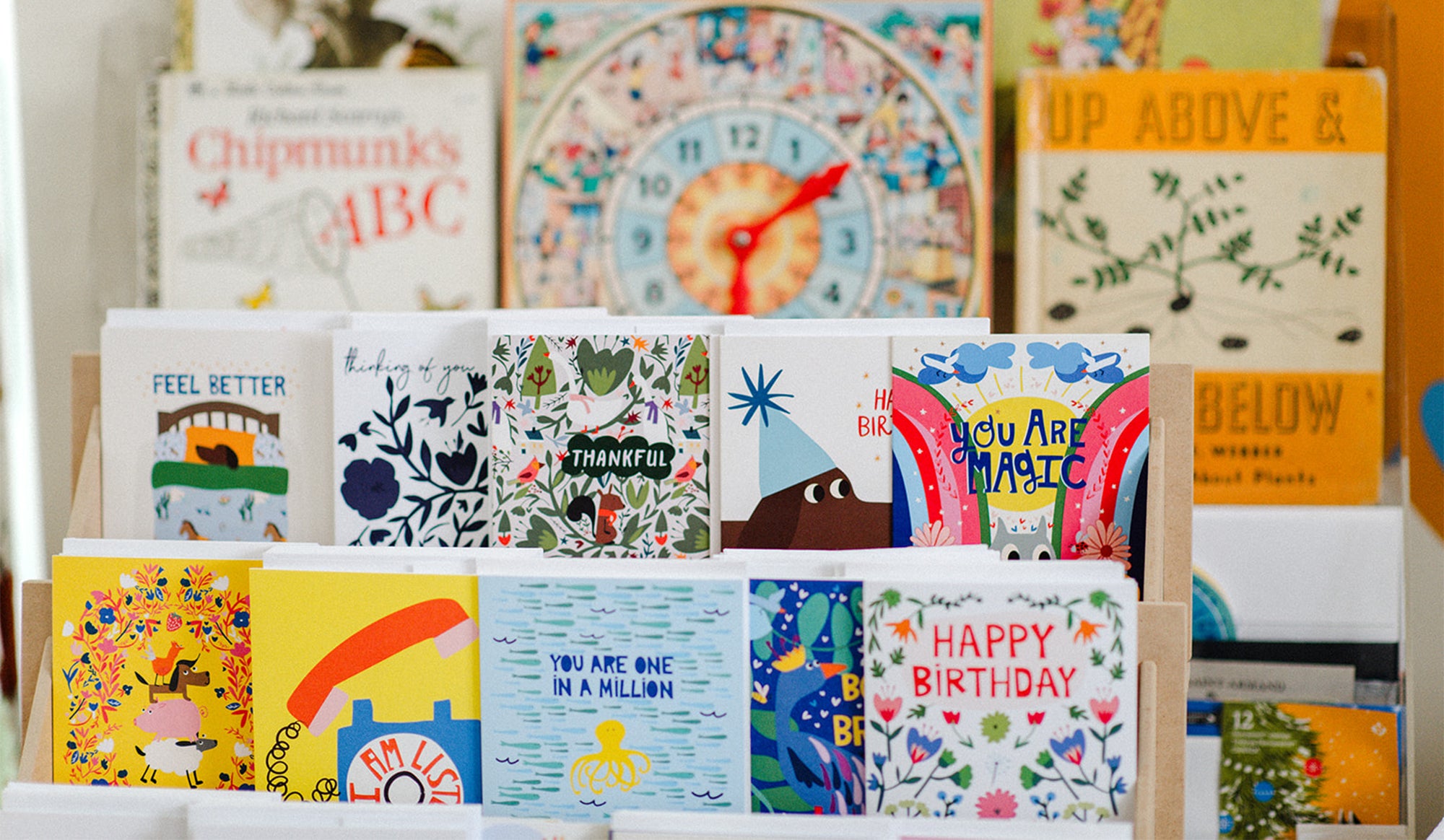 Collection of colorful greeting cards displayed on a stand