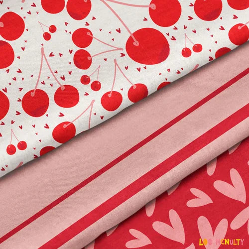 Three fabric swatches with red and pink patterns including cherries and hearts.